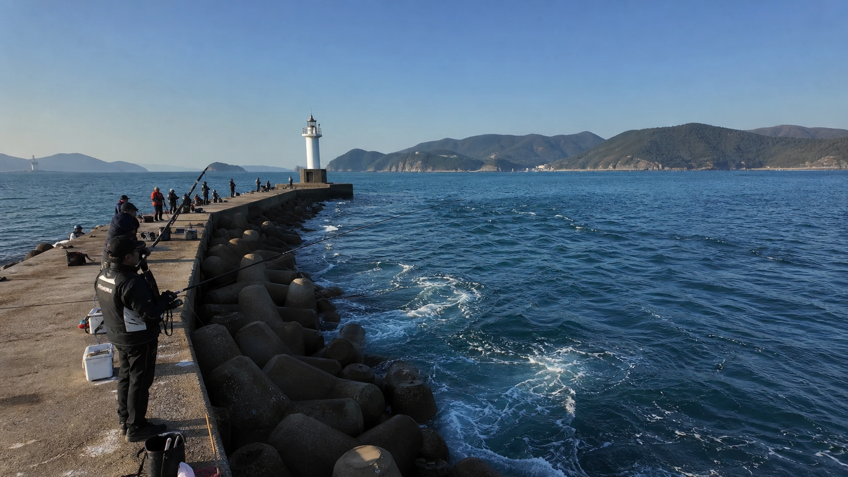Northern Geoje breakwater with deeper blue water, anglers casting toward the outer harbor, visible current lines and tetrapods, late afternoon light, realistic marine sports documentary style, high detail
