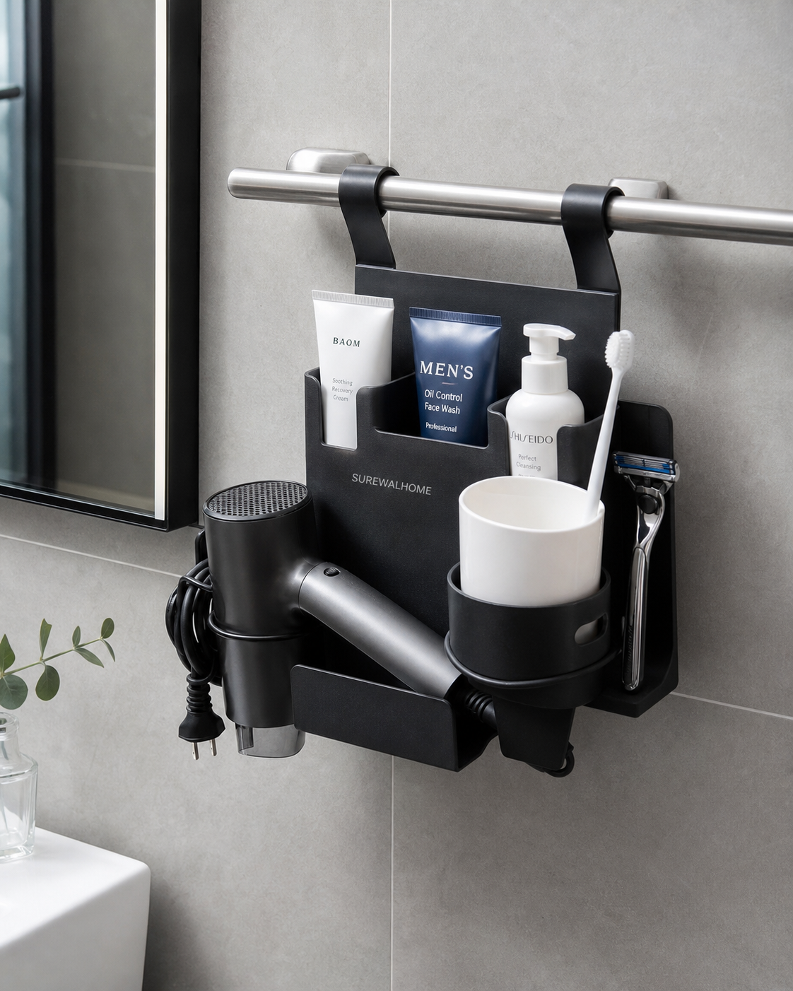 compact hanging bathroom organizer attached to a towel bar, holding hair dryer, toothbrush cup, razor, and skincare tubes, small urban apartment bathroom, clean composition, realistic shadows, neutral daylight, documentary-style product photo
