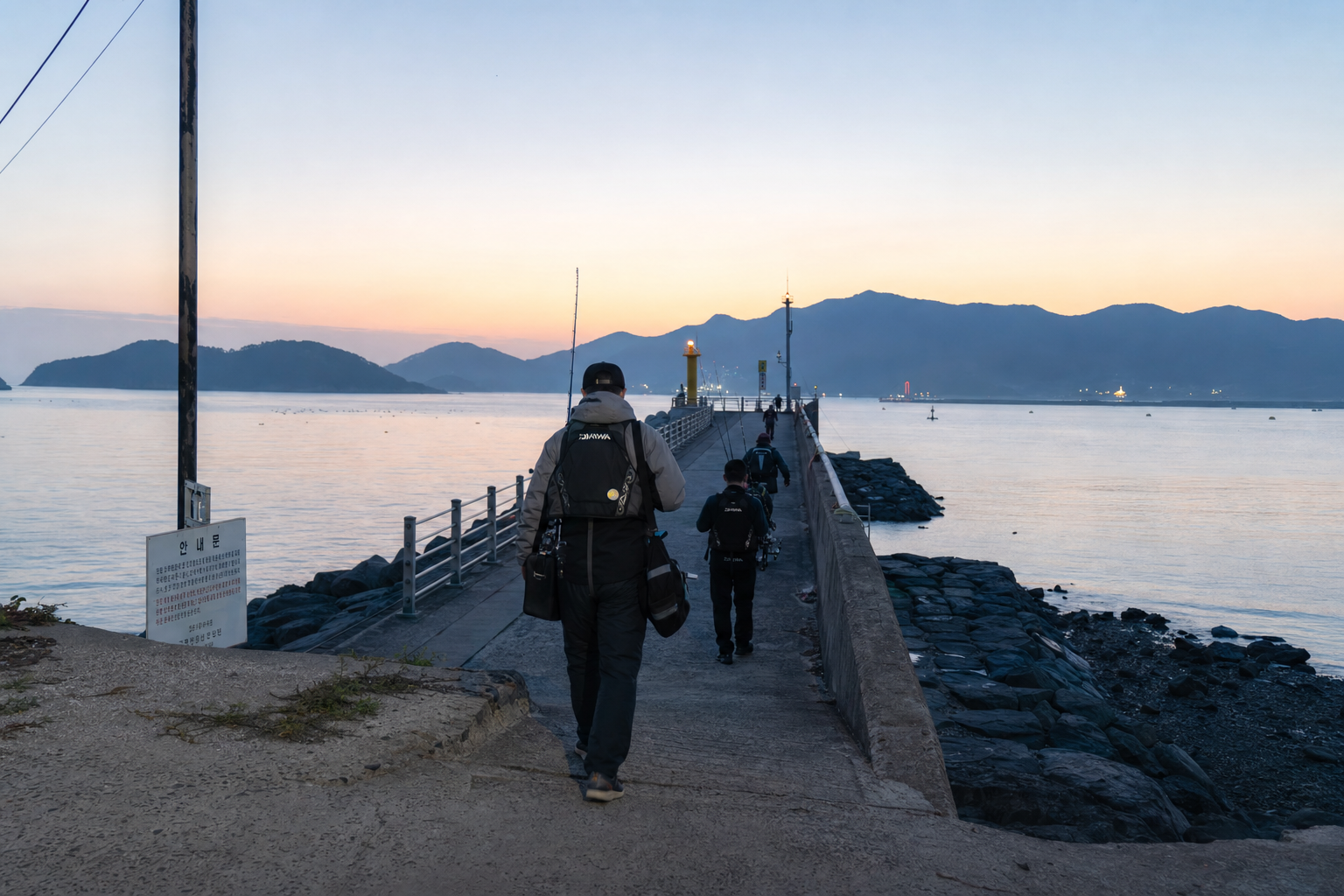 Dawn at a walkable breakwater in northern Geoje, anglers carrying eging rods from a small parking area, calm blue water, subtle lighthouse lights, realistic coastal Korea atmosphere, documentary photography style, 35mm lens, crisp detail