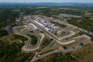 Aerial editorial shot of the Hungaroring near Budapest, winding circuit in a natural bowl, summer race atmosphere, packed grandstands, crisp motorsport magazine style, realistic, high detail